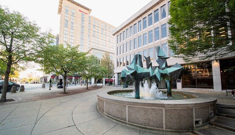 Fountain in a city in front of a Mariott hotel